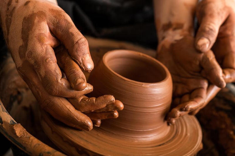 Fearfully made by God image showing a porter molding a clay jar 