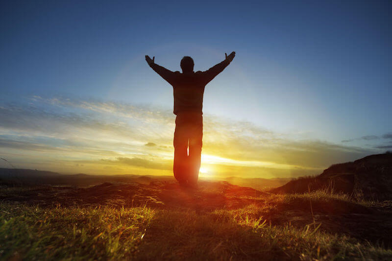 True worshippers image showing a man worshipping the Lord with hands lifted up