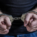 Remission of sins image showing a man in handcuffs