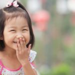 God laughs article showing a little asian girl laughing