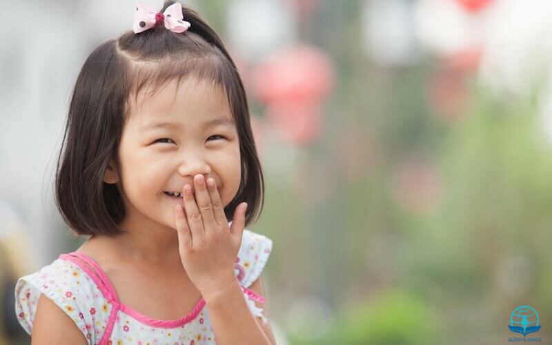 God laughs article showing a little asian girl laughing