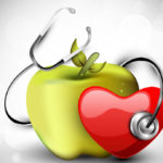 good health image showing an apple , stethoscope and a heart