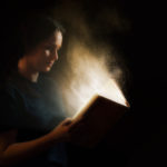 Sure Word of prophecy shows a woman reading a book that glows
