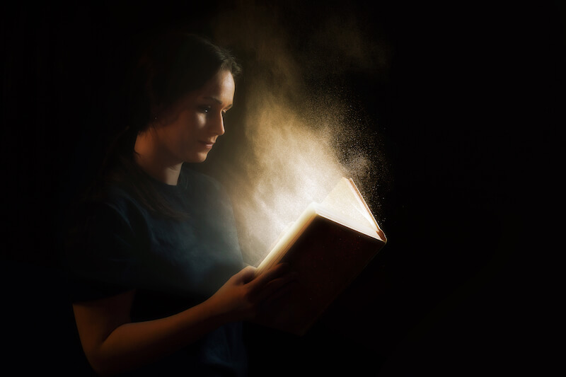 Sure Word of prophecy shows a woman reading a book that glows
