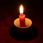 Thou wilt light my candle showing a candle in the dark