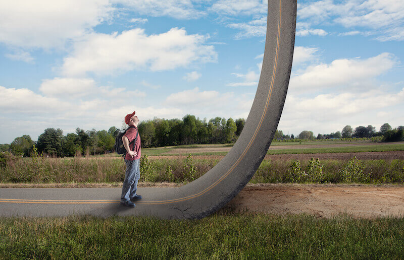 Access with confidence showing a man looking up a road that rises to heaven