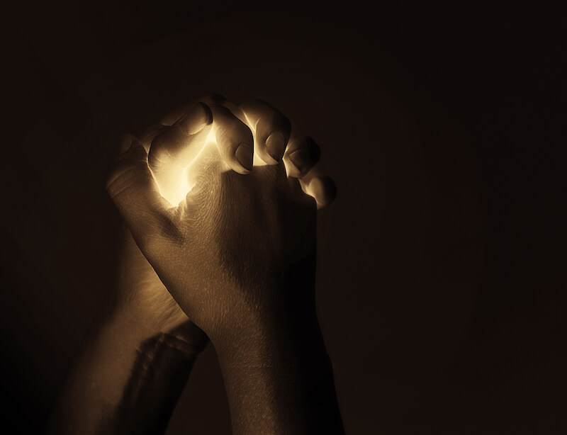 prayer showing a man's hand in prayer