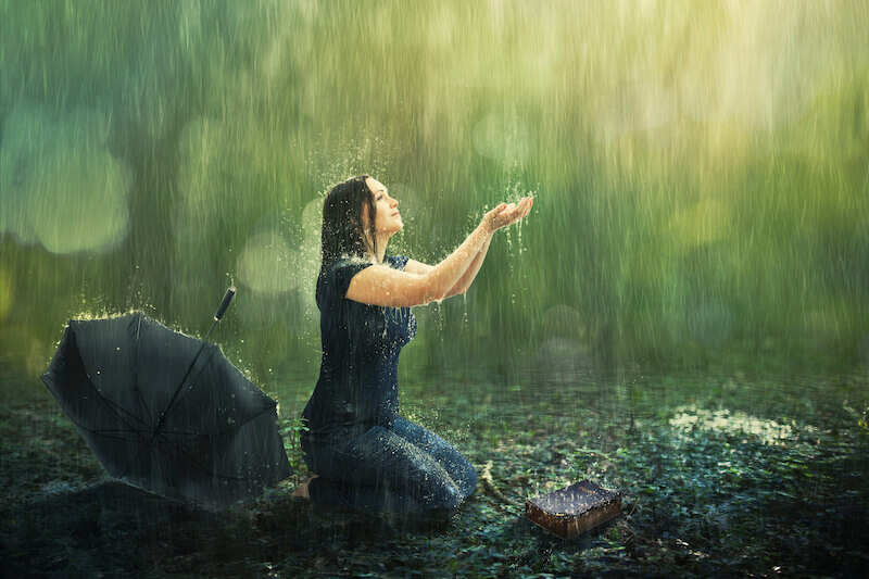 let us cleanse ourselves from all defilement of body and spirit showing a woman under the rain