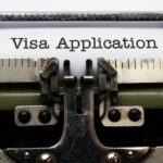 no more strangers showing a typewriter writing visa application