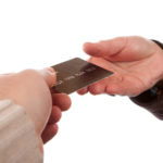 imputed righteousness showing a man handed a bank card to another