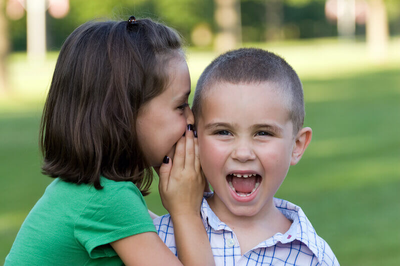 slander of grace showing a girl whispering to her brother 