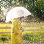 a woman in yellow rain coat under the rain