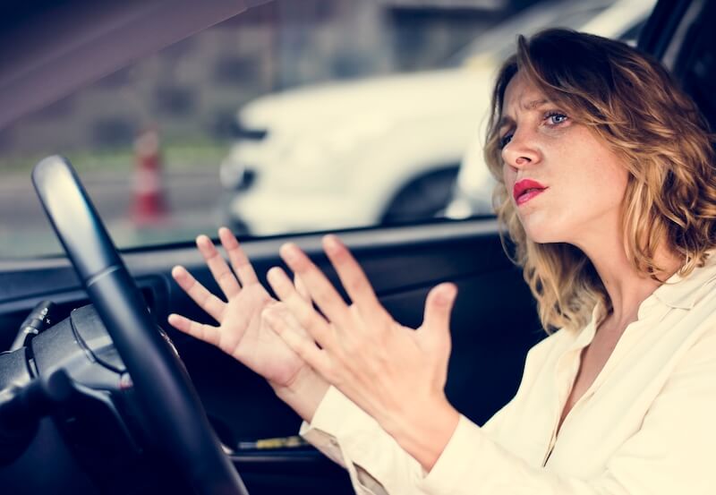 Do all things without grumbling or disputing showing a woman grumbling in her car