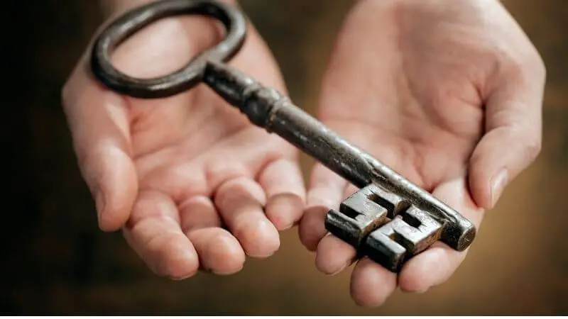 Unto You it is Given to Know the Mystery of the Kingdom of God showing a key in a person's hands