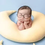 spiritual babes showing a baby on a pillow with cute glasses