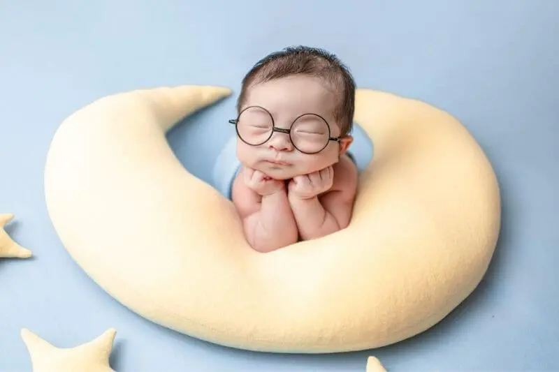 spiritual babes showing a baby on a pillow with cute glasses