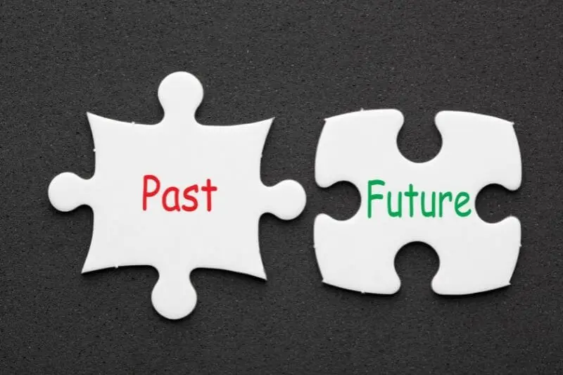 dealing with our past showing two puzzle pieces of the past and future