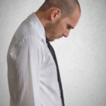 how to overcome discouragement showing a man with his head down