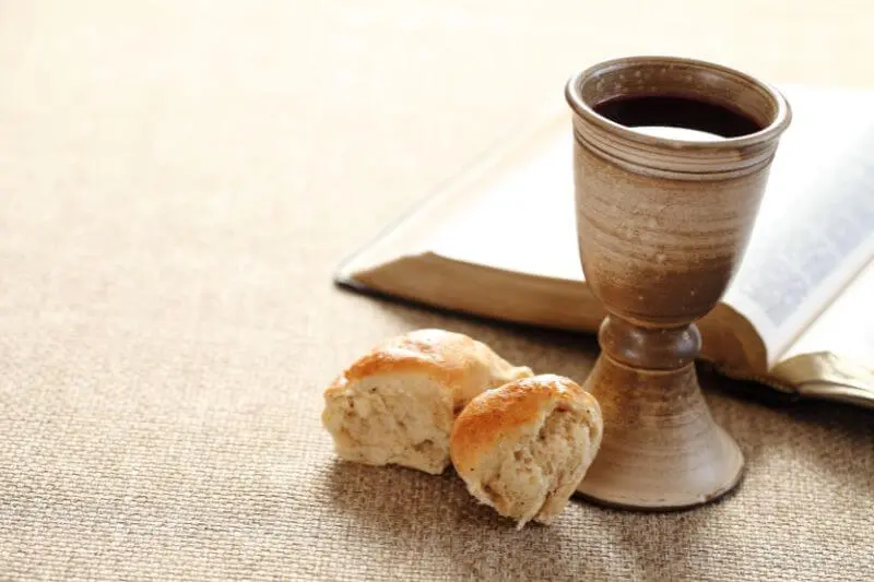 eating God's word showing the bible, with bread and wine