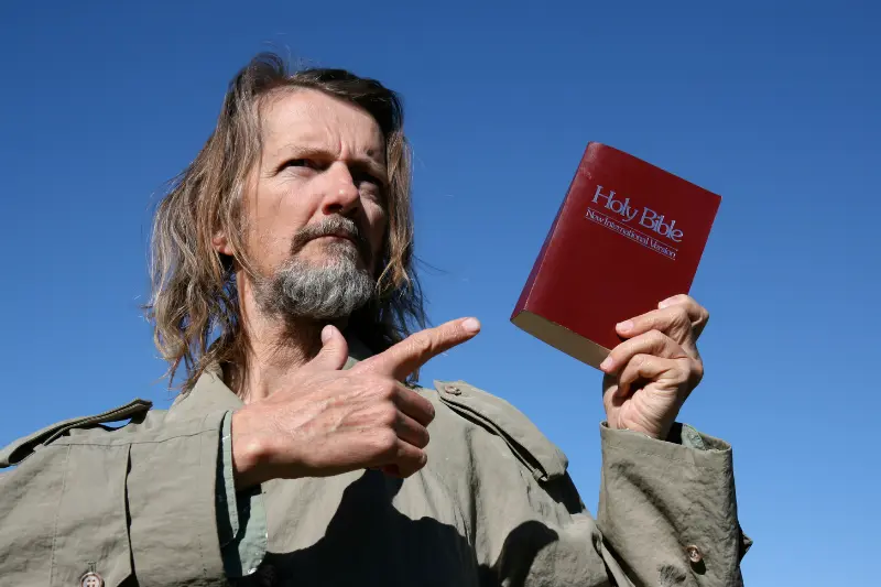 False prophets showing a man showing a Bible