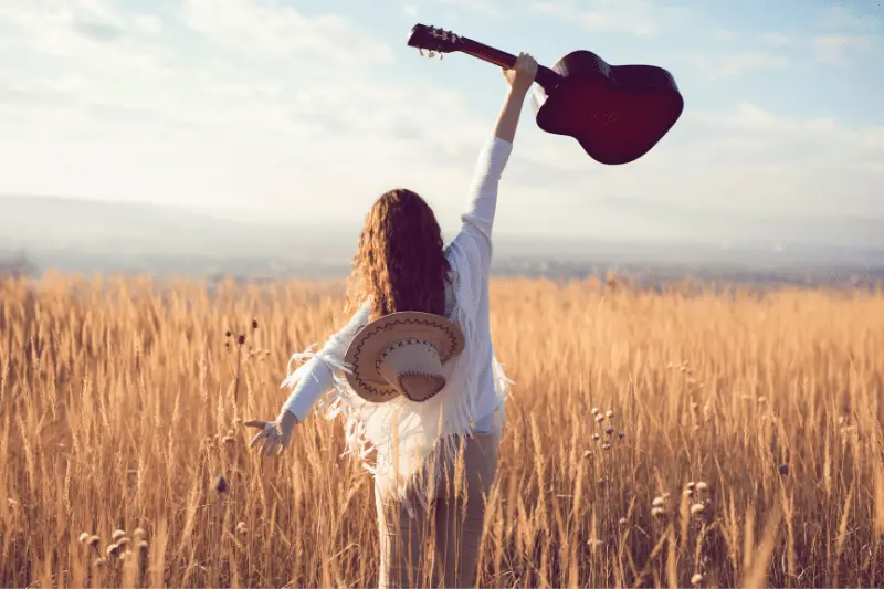 high praises showing a woman lifting up her guitar